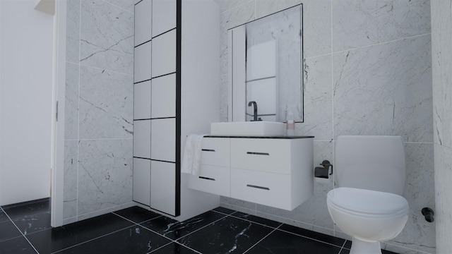 bathroom featuring vanity, toilet, and tile walls