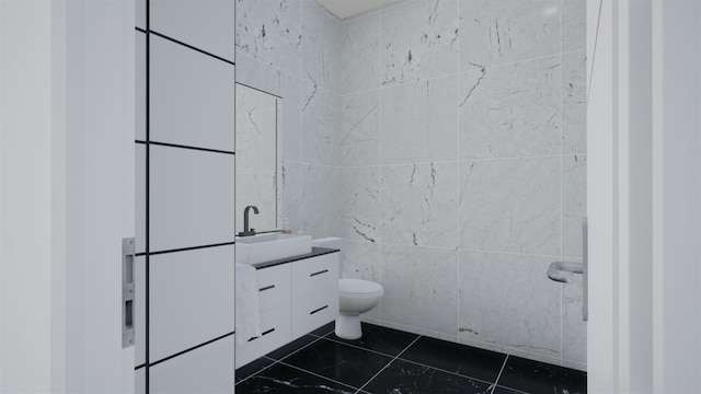 bathroom featuring tile patterned flooring, vanity, tile walls, and toilet