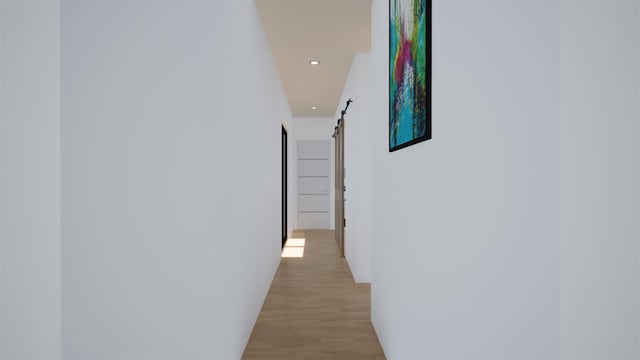 hall featuring light hardwood / wood-style floors and a barn door