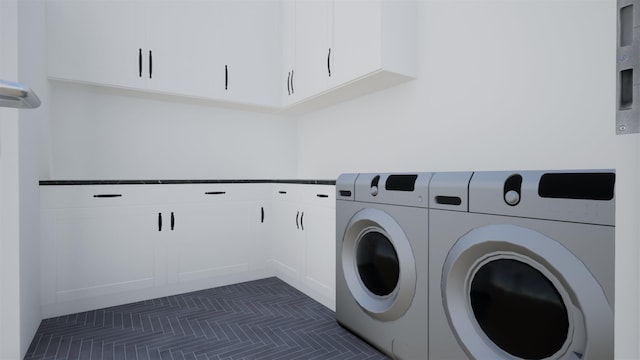 laundry room with dark tile patterned floors, cabinets, and washing machine and clothes dryer