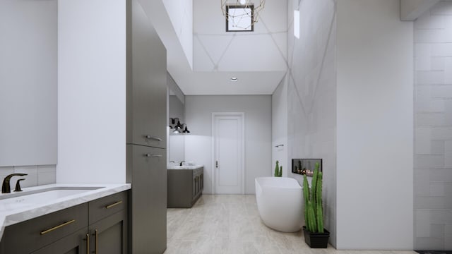 bathroom with tasteful backsplash, a tub to relax in, vanity, and tile walls