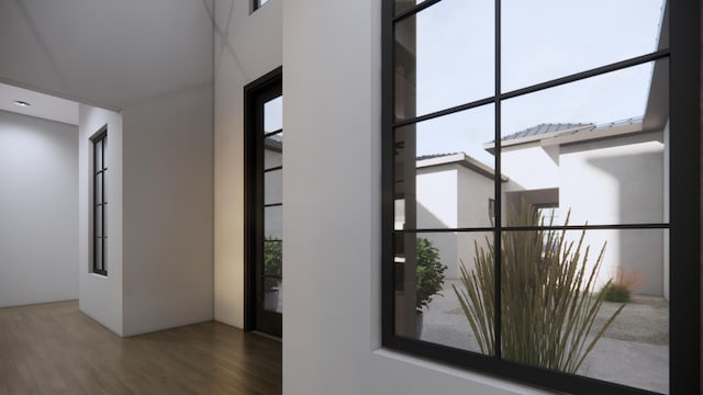 corridor with hardwood / wood-style floors