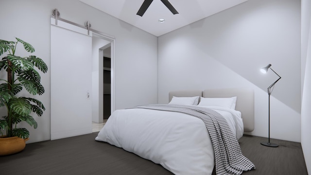 bedroom with dark wood-type flooring, ceiling fan, and a barn door