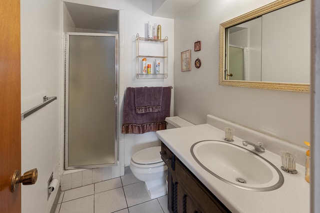 bathroom with walk in shower, tile floors, large vanity, and toilet