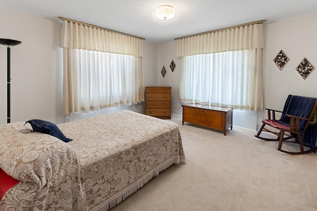 carpeted bedroom featuring a textured ceiling