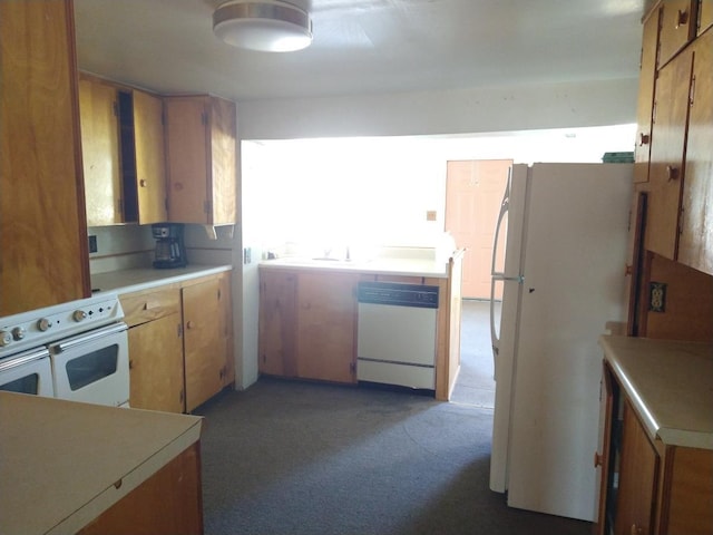 kitchen featuring dark carpet and white appliances