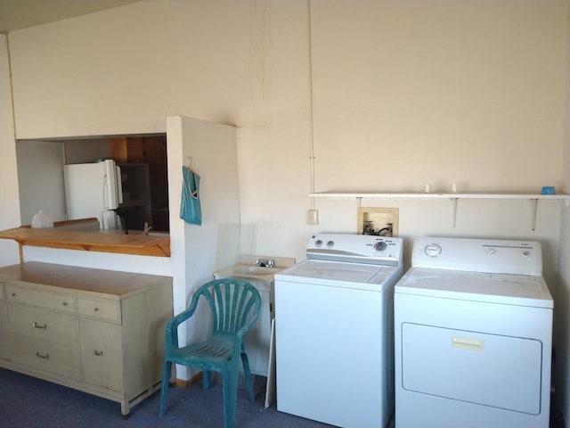 washroom featuring washer hookup, dark colored carpet, and separate washer and dryer