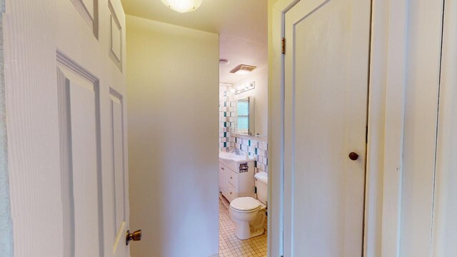 bathroom with vanity, tile flooring, and toilet