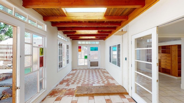 unfurnished sunroom with wood ceiling, french doors, and beamed ceiling