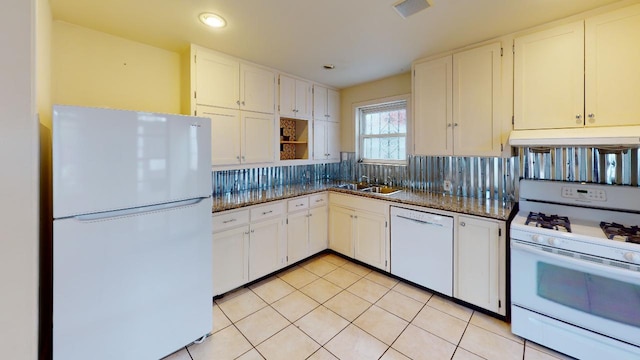 kitchen featuring white appliances, white cabinets, tasteful backsplash, and light tile floors