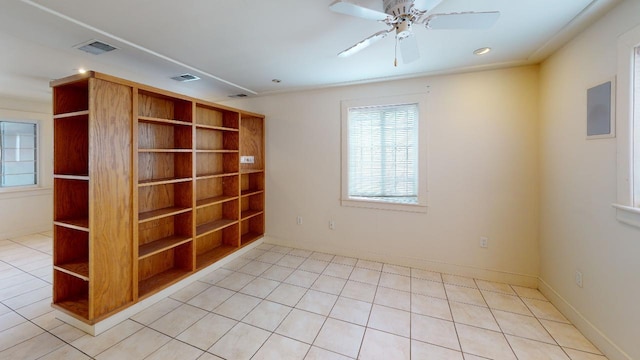 spare room with light tile floors and ceiling fan