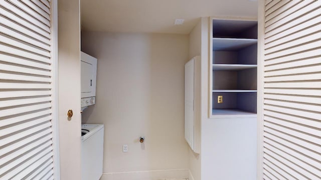 washroom featuring stacked washer / dryer