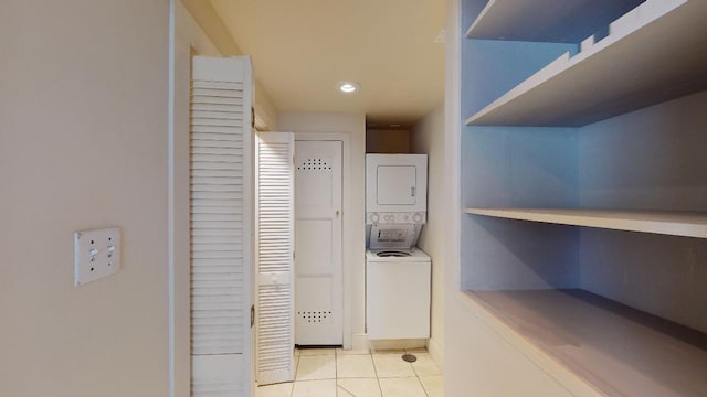 interior space featuring stacked washing maching and dryer and light tile floors