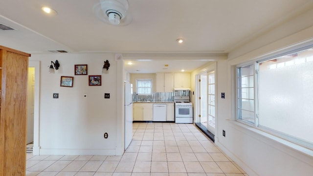 kitchen with white appliances, backsplash, and light tile flooring