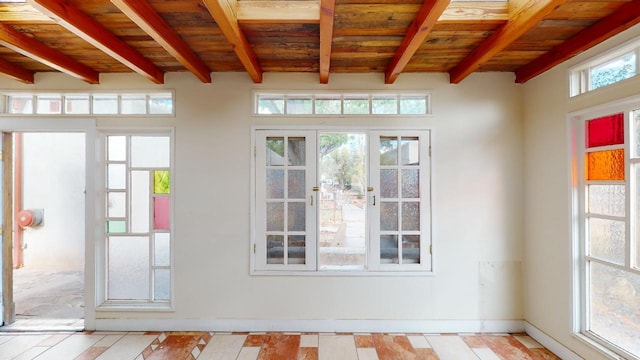 entryway featuring french doors, beam ceiling, and wooden ceiling