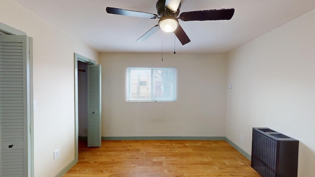 unfurnished bedroom featuring ceiling fan and light wood-type flooring