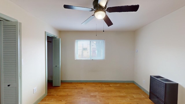 unfurnished bedroom featuring ceiling fan and light hardwood / wood-style flooring