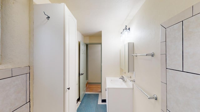 bathroom with tile floors and vanity with extensive cabinet space