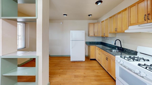 kitchen featuring white appliances, sink, light brown cabinetry, and light hardwood / wood-style floors