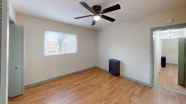 unfurnished bedroom featuring a closet, ceiling fan, and light wood-type flooring