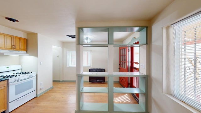 kitchen featuring light hardwood / wood-style floors and white range with gas stovetop