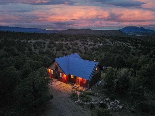 aerial view at dusk featuring a mountain view