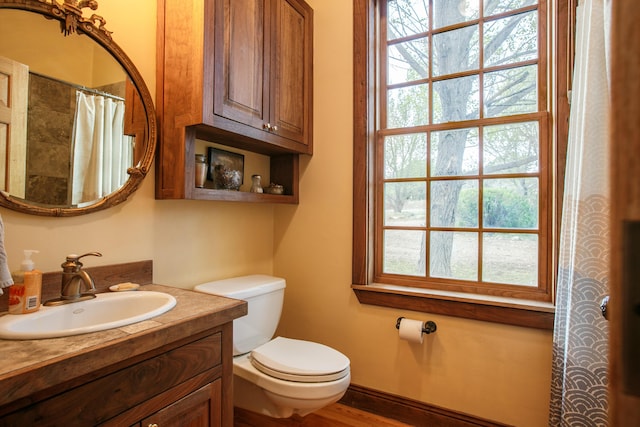 bathroom featuring vanity, toilet, curtained shower, and hardwood / wood-style floors