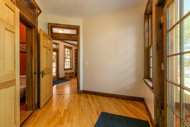 hallway with light wood-type flooring