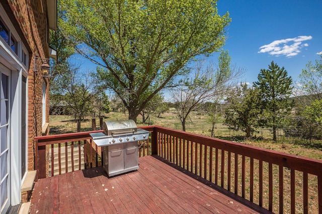 wooden deck with a grill