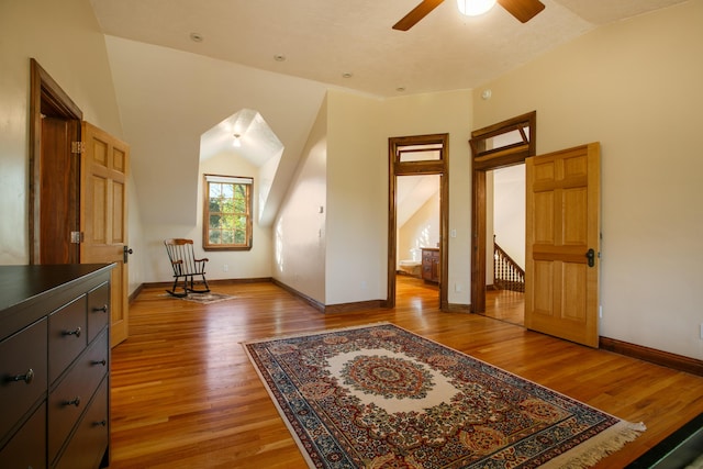 bonus room featuring lofted ceiling, hardwood / wood-style floors, and ceiling fan