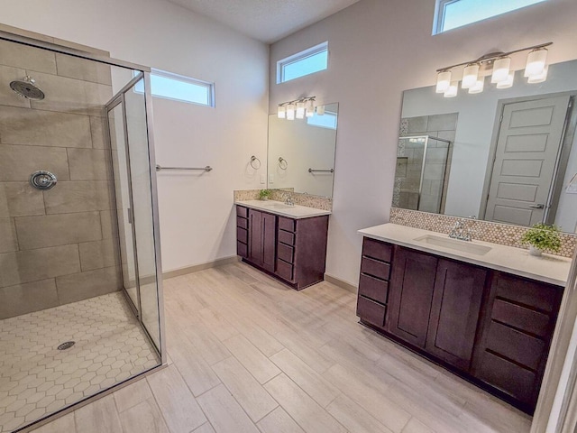 bathroom featuring hardwood / wood-style flooring, vanity, and an enclosed shower