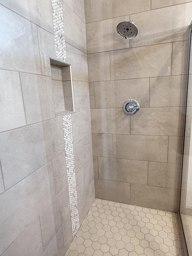 bathroom with a tile shower