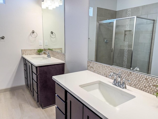 bathroom with tasteful backsplash, vanity, and walk in shower