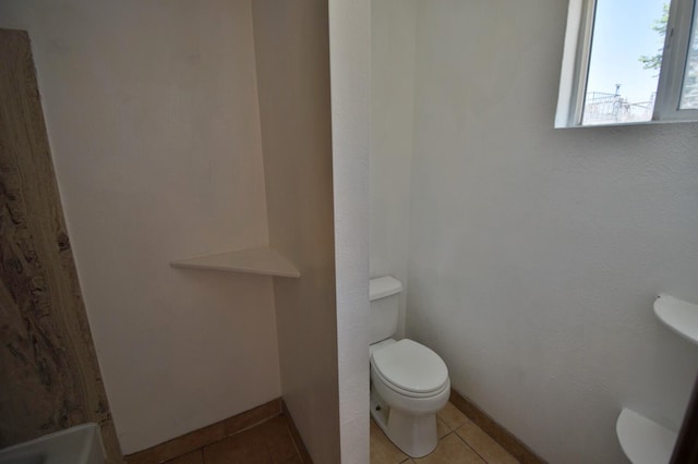 bathroom featuring tile patterned flooring and toilet