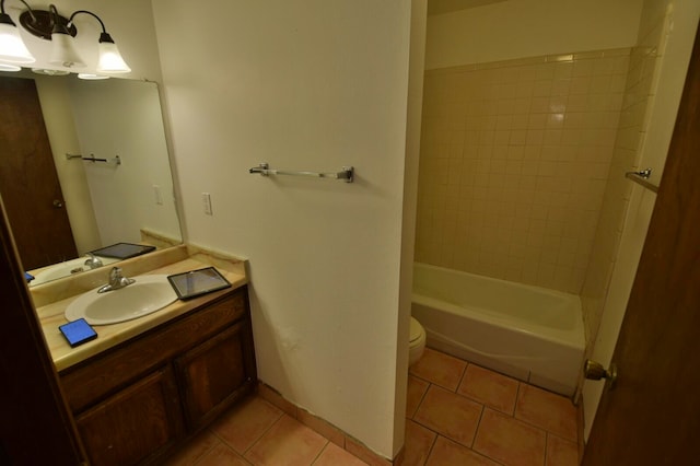 full bathroom with tiled shower / bath, vanity, toilet, and tile patterned floors