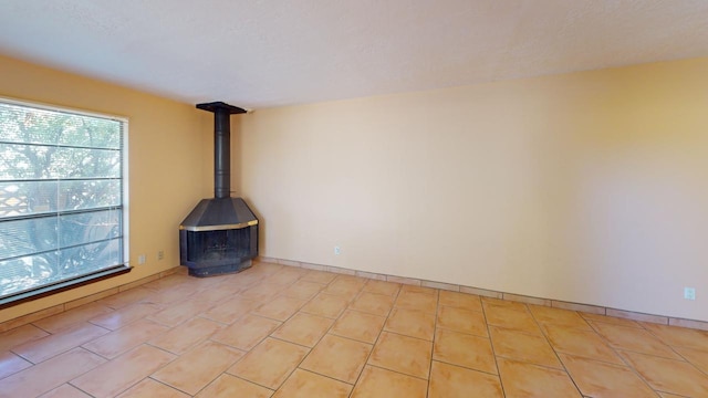 unfurnished living room with a wood stove