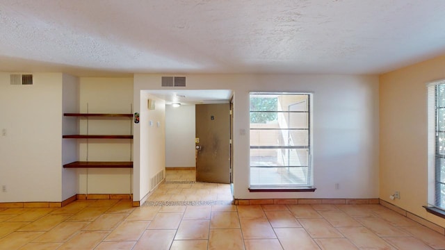 empty room with a textured ceiling