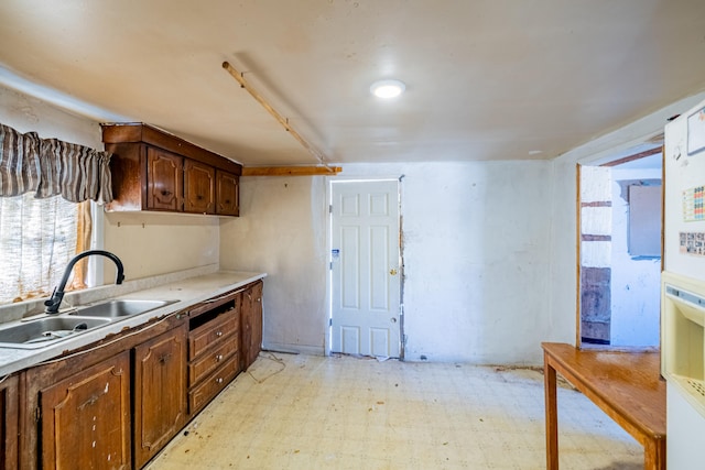 kitchen featuring light tile floors and sink