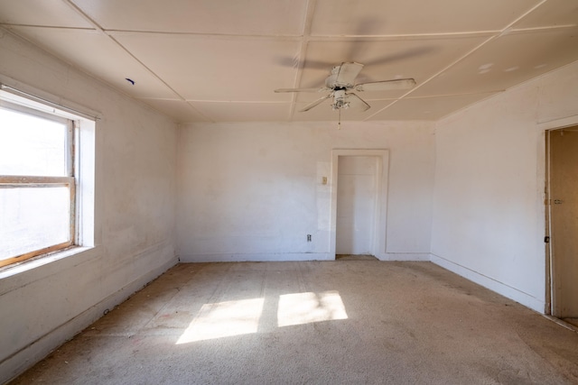 carpeted empty room featuring plenty of natural light and ceiling fan