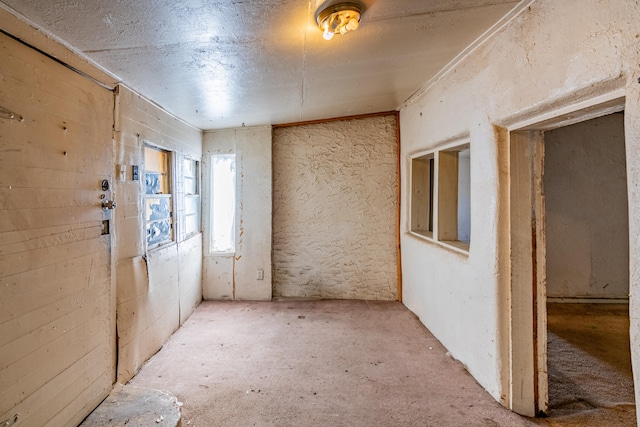 unfurnished room featuring a textured ceiling