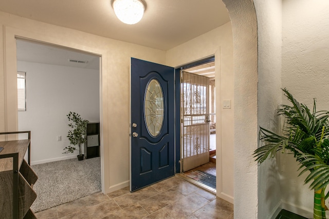 carpeted entrance foyer with a healthy amount of sunlight