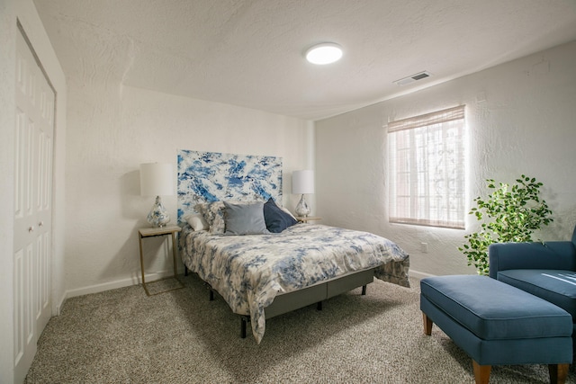 carpeted bedroom featuring a textured ceiling