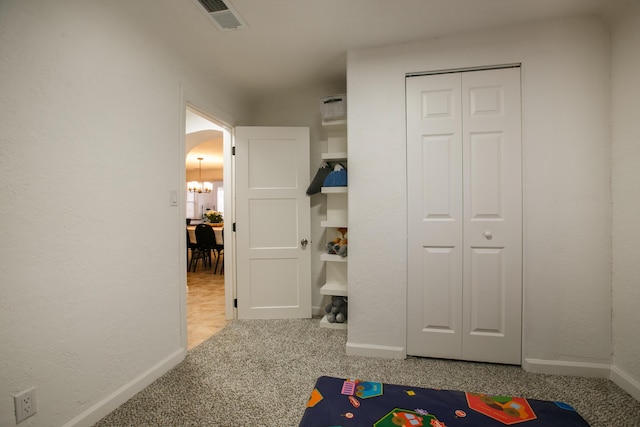 rec room featuring an inviting chandelier and carpet flooring