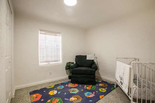 bedroom featuring carpet and a crib