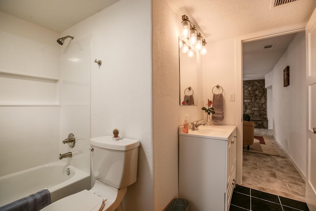 full bathroom with tile patterned floors, toilet,  shower combination, a textured ceiling, and vanity