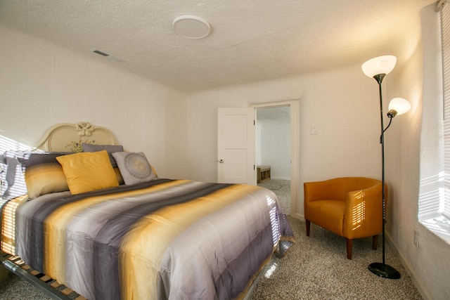 bedroom featuring a textured ceiling and carpet