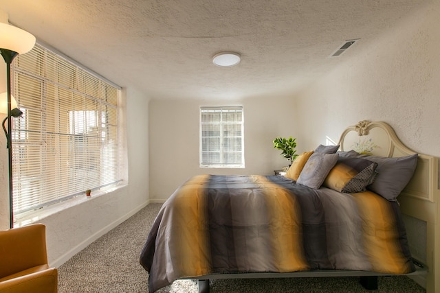 bedroom featuring carpet flooring and a textured ceiling