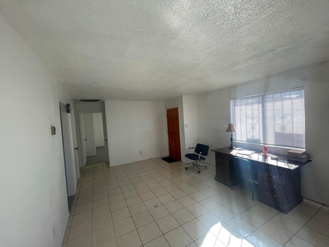 interior space featuring light tile floors and a textured ceiling