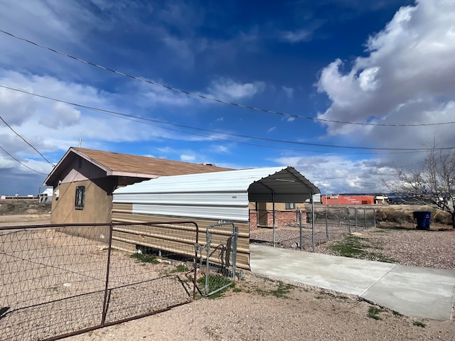 view of side of home with a carport