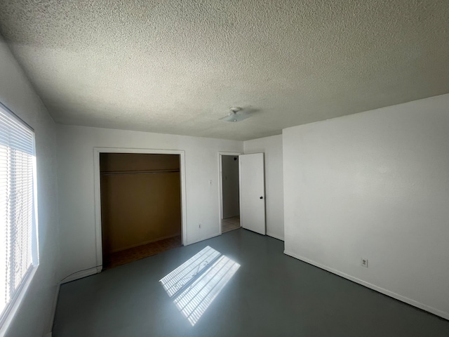 unfurnished bedroom featuring a closet and a textured ceiling